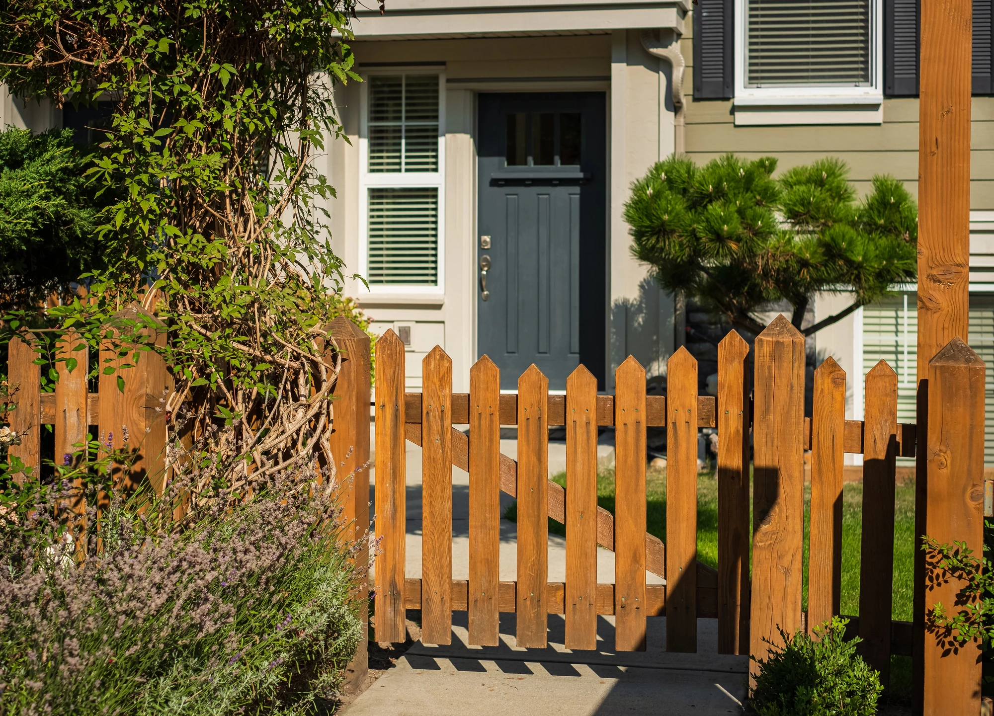 house with wooden fence made by a residential fence company near me
