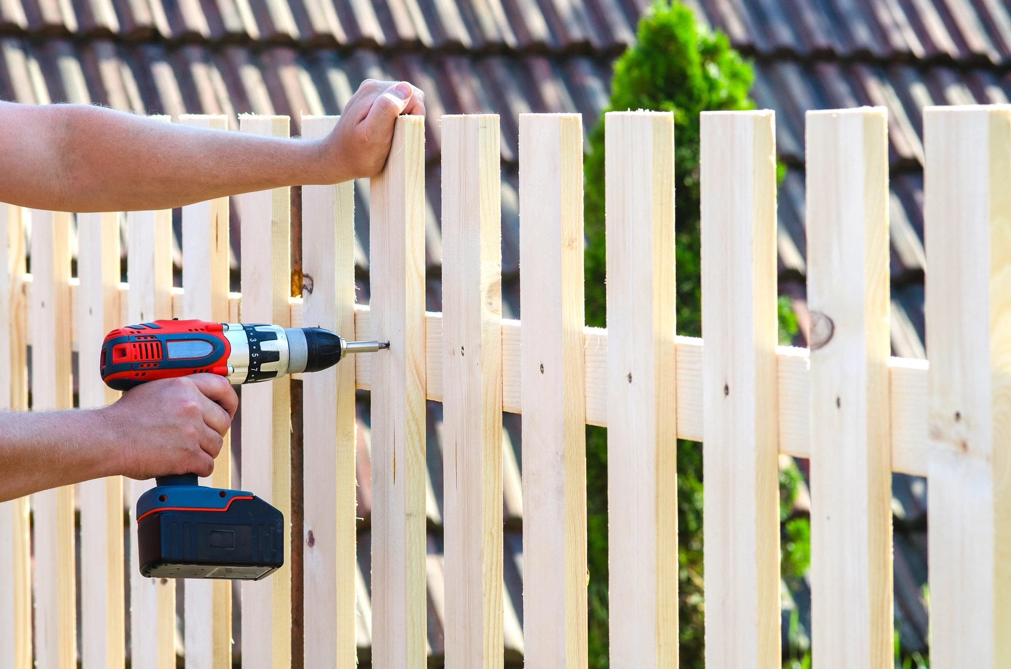 power tool being used on fence during fence repairs