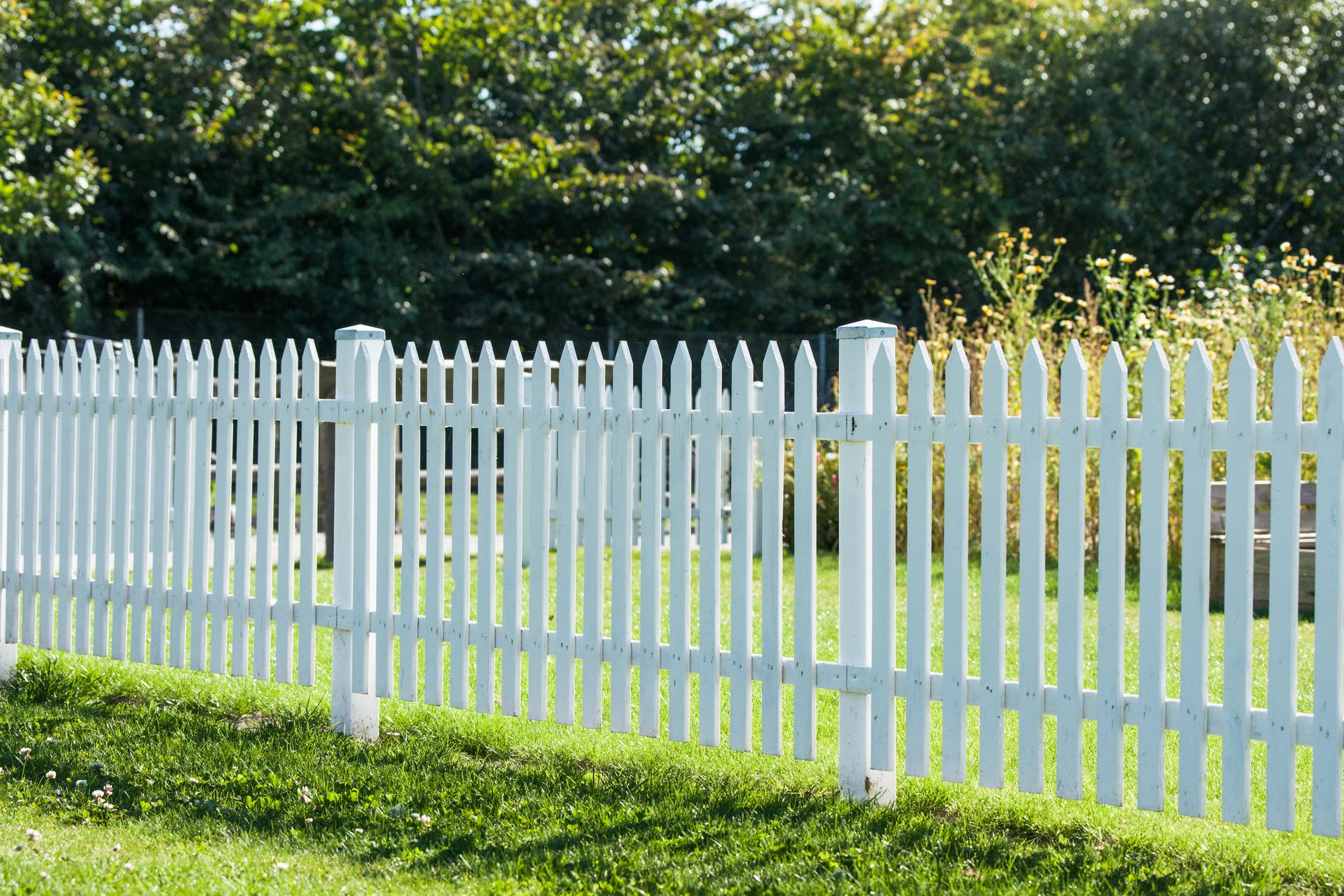 white wooden fence made by a residential fence company near me